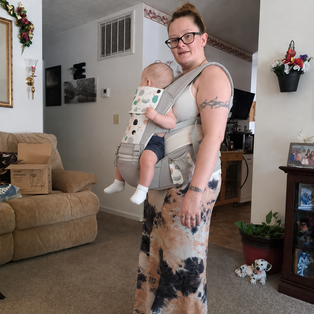 A mom wearing Grow+ in gray at home