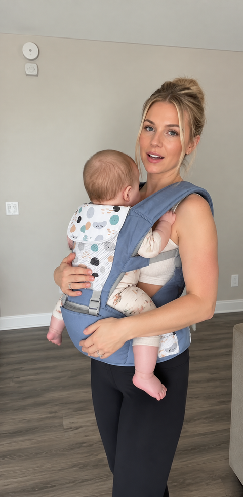 A mom wearing Grow+ with her baby facing in