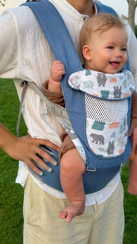 A dad wearing Grow+ with his baby facing out